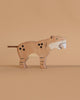 The Holztiger Saber-Toothed Tiger is a handcrafted wooden toy featuring painted spots, stripes, and white fangs. Made in Europe with great attention to detail, it stands out against a plain beige background.