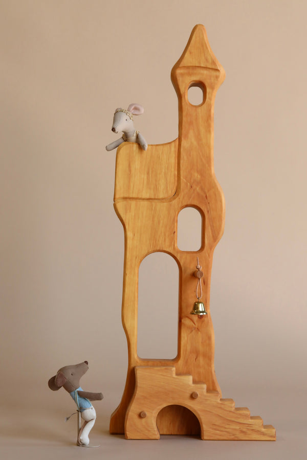 The Ostheimer Fairytale Tower with Maileg Romeo and Juliet Set features two handcrafted mice: one below, gazing up, and one near the top window. A small bell hangs from the tower—all set against a plain beige background.