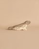 A Holztiger Handmade Wooden Ocean Animals Set toy seal with grey and natural wood coloring and painted spots.