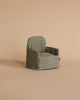 The Maileg Cozy Christmas Set features a small green and beige checkered armchair, perfectly sized for a Maileg Winter Ski Mouse, displayed against a light beige background and ideal for dollhouse setups.