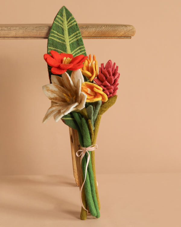 The Handcrafted Felt Flower Bouquet features vibrant felt blooms with green stems and leaves, tied with a light ribbon—a sustainable, eco-friendly floral arrangement perfect for any occasion.