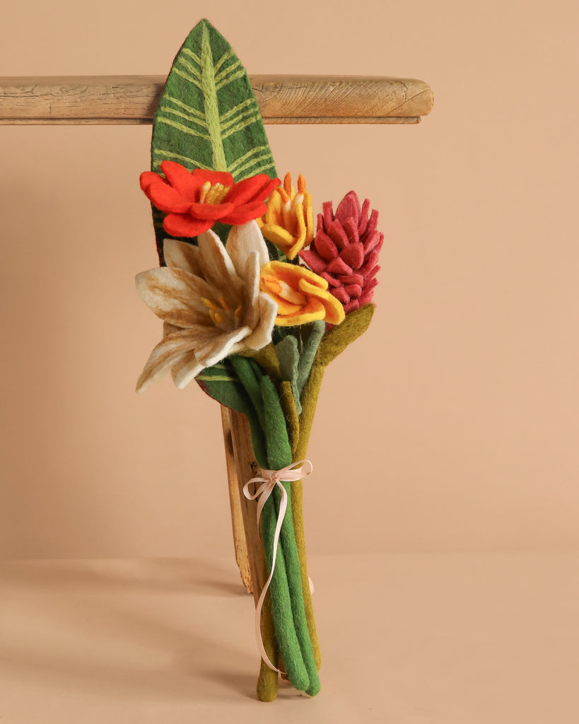 The Handcrafted Felt Flower Bouquet features vibrant felt blooms with green stems and leaves, tied with a light ribbon—a sustainable, eco-friendly floral arrangement perfect for any occasion.