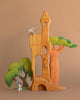 The Ostheimer Fairytale Tower with Maileg Romeo and Juliet Set features two small mice interacting in a wooden castle with colorful trees on a brown backdrop. A bell hangs in the arched doorway, highlighting classic handcrafted charm.