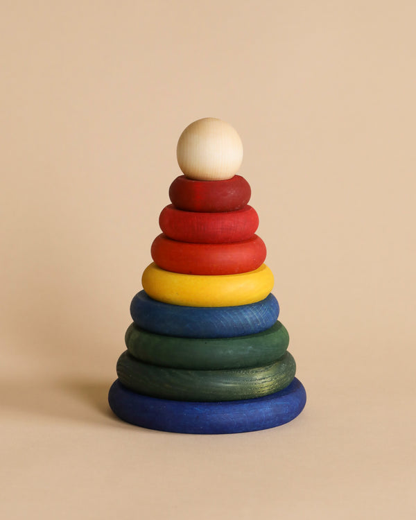 A Rainbow Wooden Stacker against a beige background.