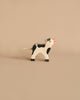 Holztiger Handmade Wooden Black & White Cow Family Set featuring a handcrafted wooden cow with black spots, a pink muzzle, and a cord tail, perfect for imaginative play.
