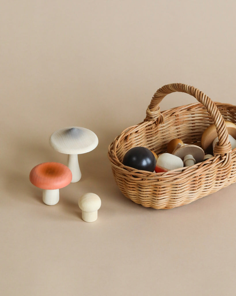 Wooden mushroom toys in a woven basket.