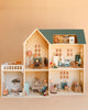 The Maileg Fully Furnished Dollhouse Set (Restock Expected In August) is a beautifully detailed miniature home featuring multiple rooms—kitchen, bathroom, bedroom, living room, and laundry area—each thoughtfully decorated with charming dollhouse furniture and accessories. Plus, enjoy a special gift with purchase!.