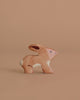 The Holztiger Rabbit is a small, handcrafted wooden toy figurine with painted details, shown on a solid light brown background, reflecting the charming European style of HOLZTIGER products.