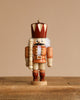 The Christian Ulbricht Collectible Wooden Nutcracker - King (Natural) stands on a rustic wooden surface against a plain beige background.