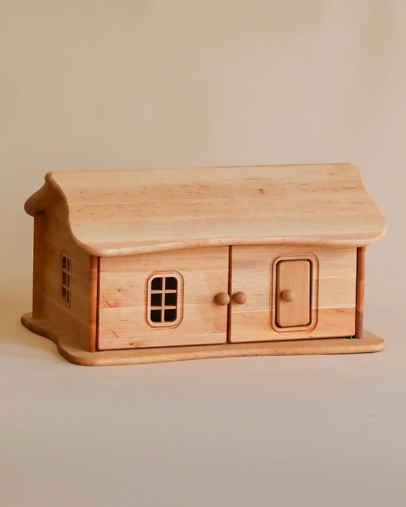 Fully Furnished Cottage Dollhouse-shaped box with detailed windows and a door, crafted from light-colored wood, displayed against a plain beige background.