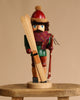 The Christian Ulbricht Collectible Wooden Nutcracker - Skier features a festive figure in a red hat, scarf, and green coat, holding skis and a ski pole—a delightful addition to any nutcracker collection.