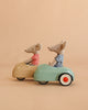 LouiMax and Stella from the Maileg Adventure Set, dressed in striped shirts, sit in charming vintage-style beige and blue Maileg cars against a plain beige background.