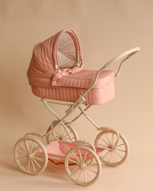 An elegant vintage style Doll Pram - Mahogany Rose on a beige background, featuring white EVA material wheels and a shiny metallic frame, displaying classic design with a modern touch.