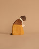 This Ostheimer Nativity Scene - Extended wooden sculpture features a figure adorned in a hat and coat, crafted from sustainable materials in various shades of brown and yellow, set against a neutral background. It evokes the warmth and creativity reminiscent of handcrafted wooden toys.