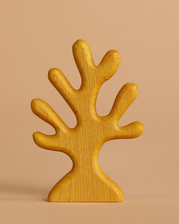 The Handmade Holzwald Yellow Coral is a simple, stylized wooden figurine with multiple rounded branches painted yellow, standing upright against a light beige background.