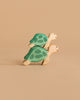 Two Handmade Holzwald Sea Turtle wooden toys, in green and beige, are stacked together against a plain beige background—ideal for creative underwater play setups.