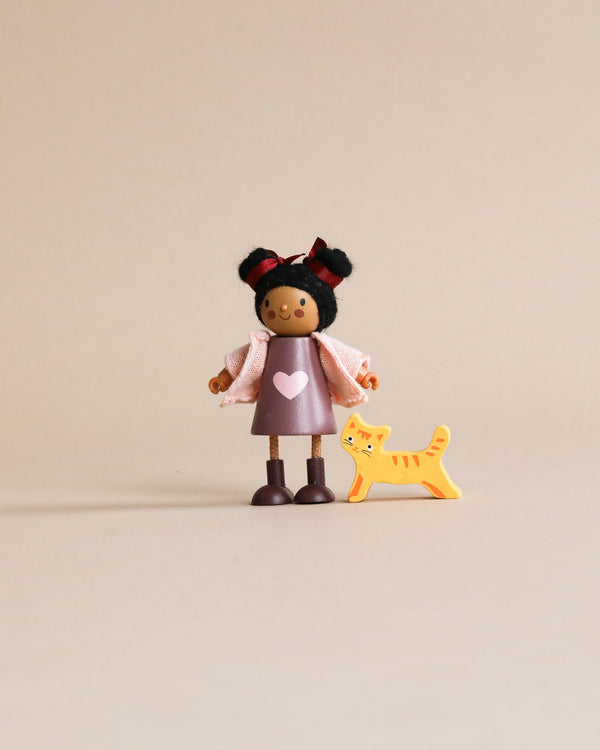 A small toy figure of Ayana with her Cat, suitable for Age range 3 Years And Older, and a toy orange