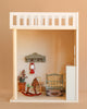Create a cozy dollhouse scene with the Maileg Bonus Room Bedroom Set, featuring a miniature bed, rocking horse, clock, potted plant, lantern on a shelf, and suitcase on a rug—perfect for charming dollhouse decor.