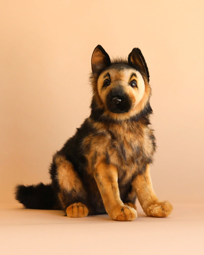 The German Shepherd Puppy Dog Stuffed Animal from the renowned HANSA animals collection sits upright on a light beige background, looking forward with perked ears and soft, fluffy brown and black fur.