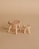 The Maileg Big Sister Getting Ready Set includes two small, light wooden stools—one larger than the other—ideal as a Maileg Mouse stand. With three legs and neutral tones, they add charm to any miniature scene.
