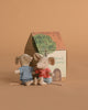 The Maileg Nursery Set with Brothers and Sisters features two mice in striped shirts—one blue, one red—seated side by side before a painted cardboard house, creating a charming display of beloved baby mouse accessories.