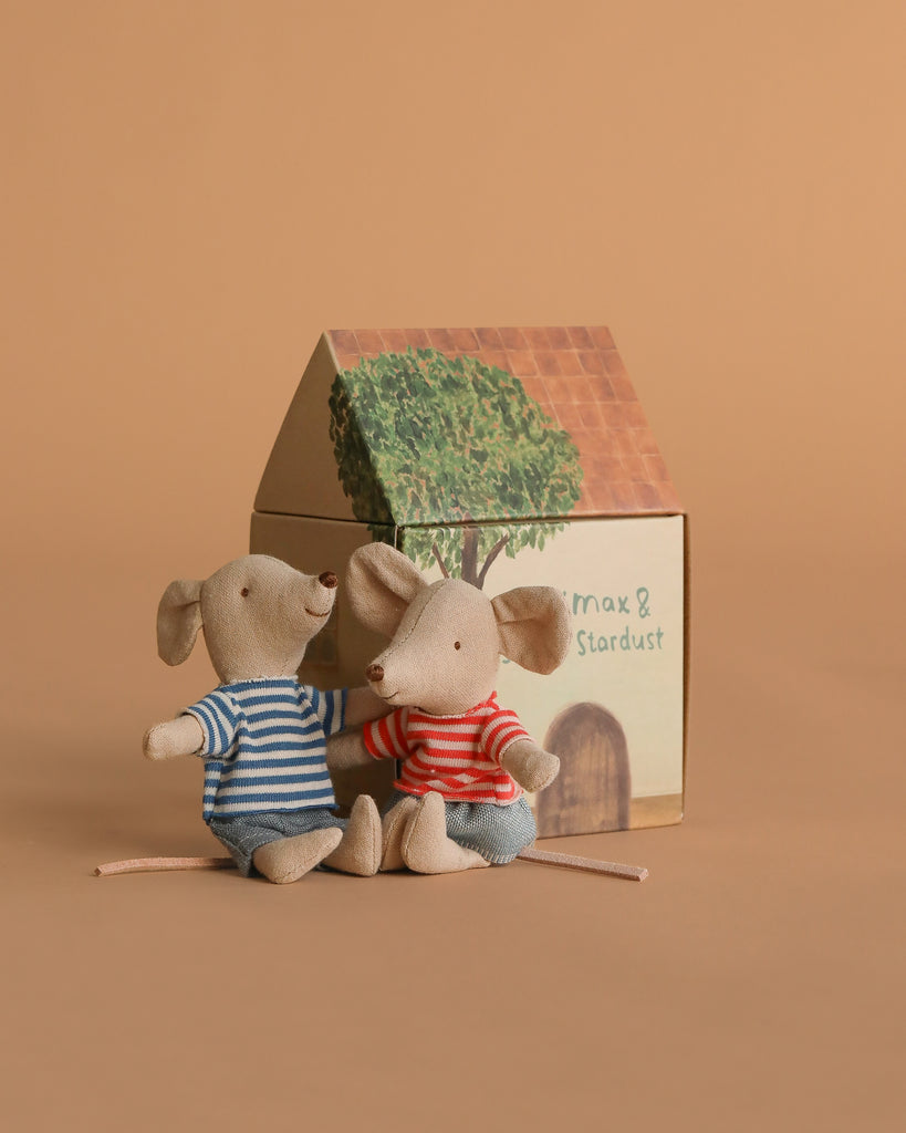The Maileg Camping Set with Brother and Sister features two small mice in striped shirts sitting together outside a charming illustrated house accessory labeled "max & stardust," all set against a plain brown background.
