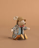 The Maileg Granddad Mouse, made from cotton and recycled polyester, sits upright on a beige background in a plaid jacket, checked shirt, brown hat, red bow tie, and brown pants.
