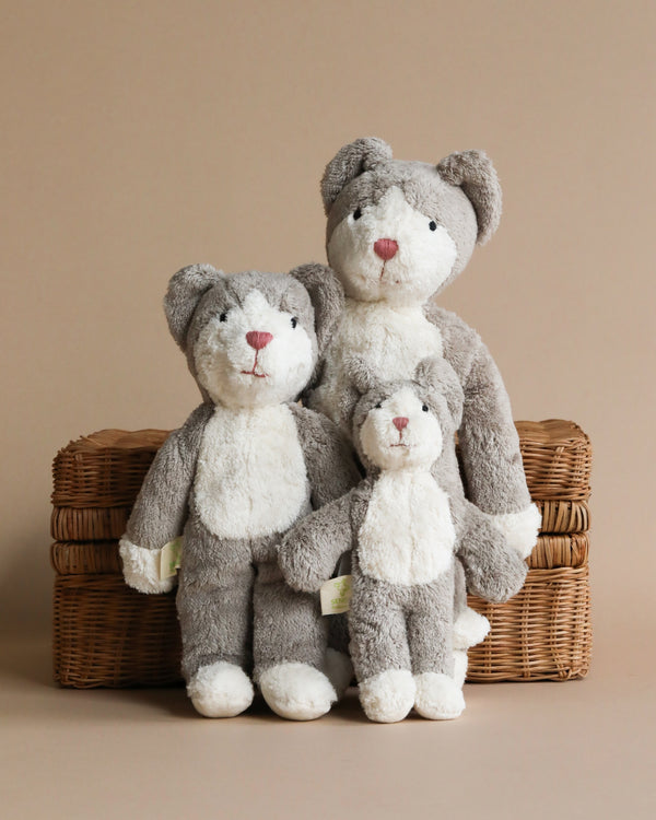 Three Senger Naturwelt Stuffed Animal - Cat toys of varying sizes, handmade in Germany and positioned in a wicker basket against a neutral background.