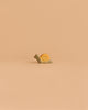 The Handmade Holzwald Small Snail, a delightful yellow toy with a spiral shell, rests on a flat surface against a plain beige background—perfect for inspiring imaginative play and appealing to creative minds.