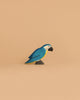 The Handmade Holzwald Blue Parrot is a small, colorful wooden figurine featuring blue, yellow, and white markings—ideal for anyone who appreciates sustainable and decorative wooden toys.