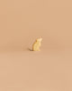 The Handmade Holzwald Mouse - Standing, a small wooden figurine with a thin tail, is displayed on a plain light beige background.