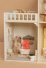 The Maileg Fully Furnished Dollhouse Set + Surprise Gift includes a charming bathroom with doll, bath accessories, and a cozy loft with table and chairs for endless miniature fun.