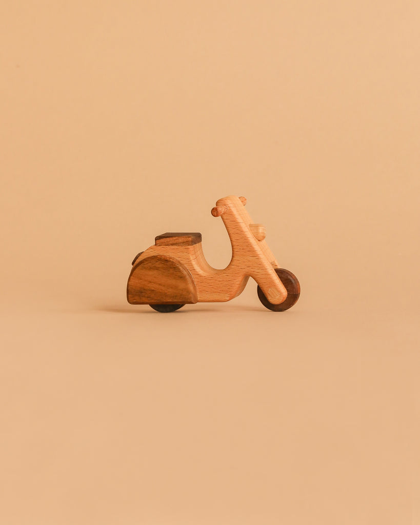 The Handmade Wooden Scooter, crafted from beech wood with smooth, simple edges, sits on a neutral beige background.