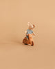 A small plush mouse in a striped shirt sits on the Handmade Wooden Scooter, crafted from beech wood, shown against a plain beige background.