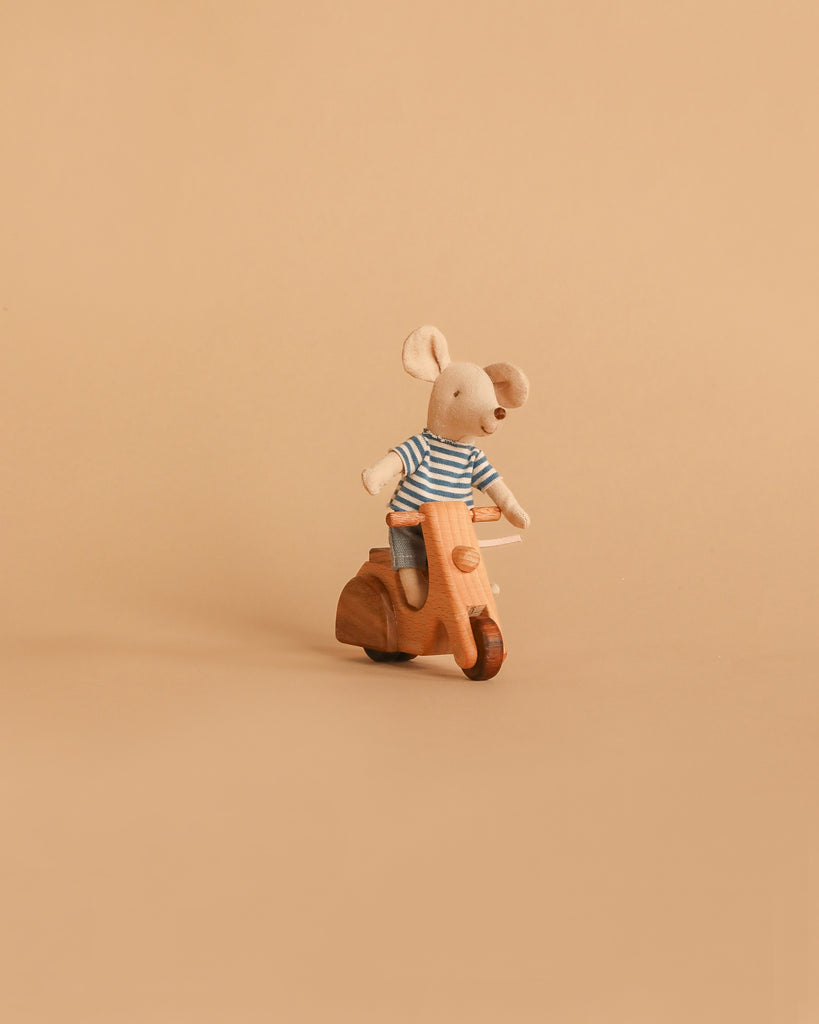 A small plush mouse in a striped shirt sits on the Handmade Wooden Scooter, crafted from beech wood, shown against a plain beige background.