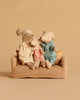 The Maileg Family Time Set features three stuffed toy mice—Mum and Dad Mice with the Little Sister Mouse sitting between them—arranged on a small checkered Maileg couch against a plain beige backdrop. The Little Sister Mouse is dressed in pink, while Mum and Dad wear blue and white outfits with orange dots.