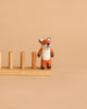 The Felt Finger Puppet: Fox stands on a wooden peg board against a plain beige background, perfect for imaginative storytelling.