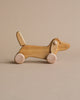 Natural color wooden dachshund dog push toy. 
