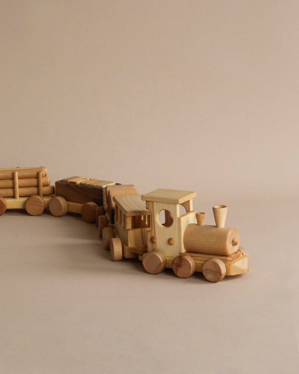 A Handmade Wooden Train - Extra Long with multiple carriages on a neutral background, featuring simple, smooth designs and natural wood tones.