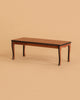 A rectangular wooden coffee table with curved legs, set against a plain beige background, makes the perfect display for the Maileg Family Celebration Set or can be paired charmingly with a Maileg mouse set.