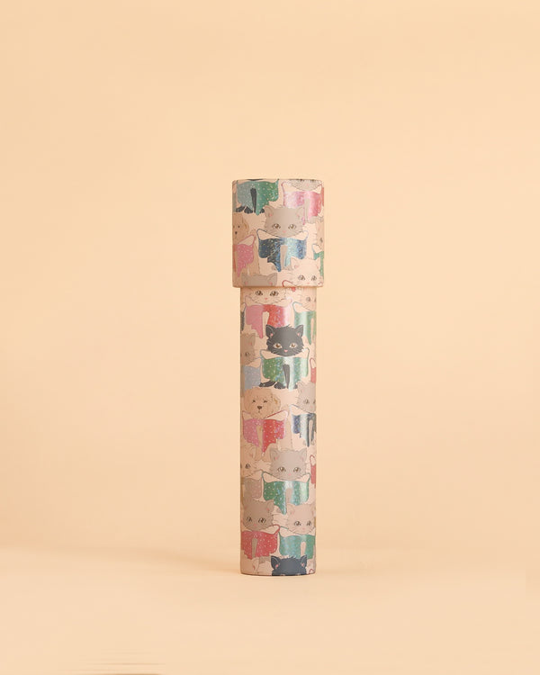 The Konges Sloejd Kaleidoscope - Like Cats and Dogs is a tall cylindrical container crafted from FSC-certified cardboard, featuring whimsical cartoon cats in sweaters and displayed upright against a plain beige background.