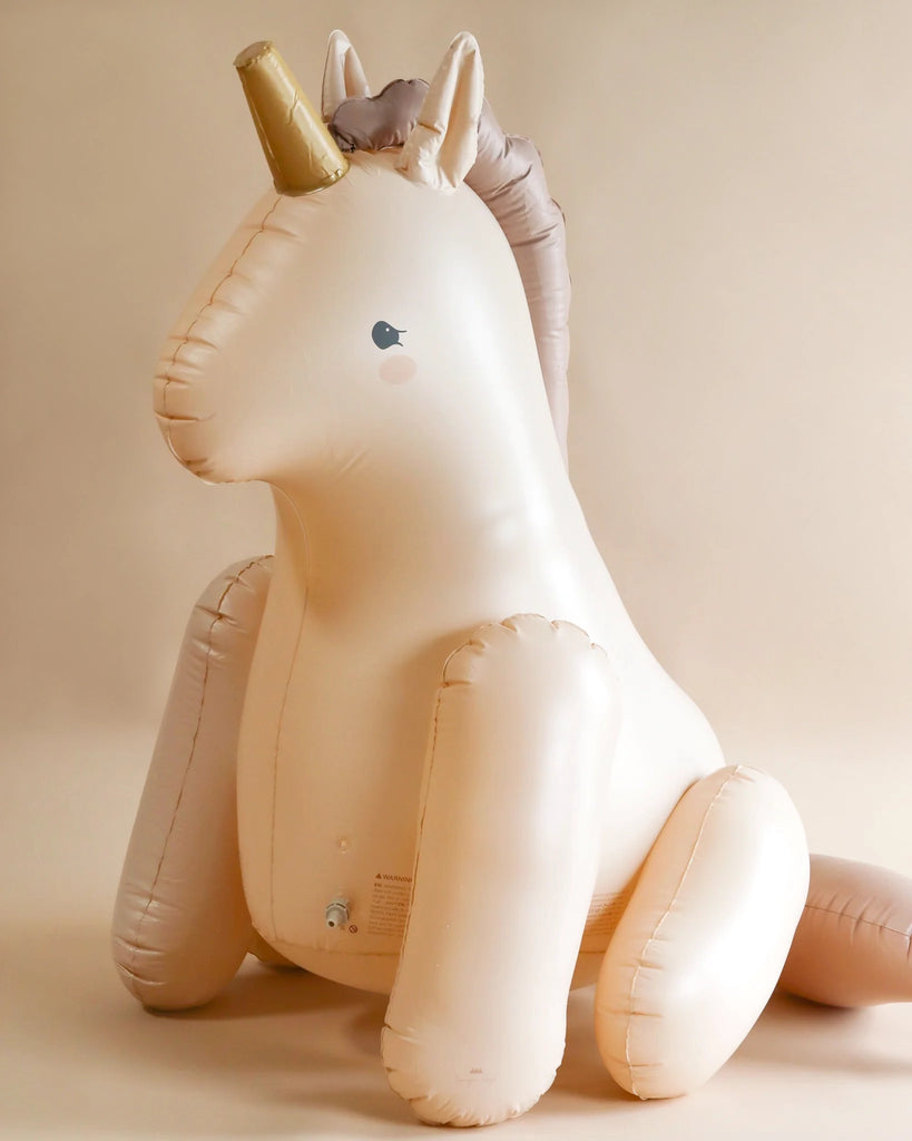 Inflatable Giant Unicorn Sprinkler with silver horn made from durable PVC, sitting against a plain background, featuring minimalistic design and a subtle sheen on its surface.