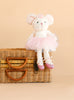 A Bukowski - Antonia Mouse - White plush toy dressed in a pink tutu and ballet shoes sits on a wicker basket against a beige background.