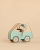 A Maileg Little Brother Driver Set, featuring a mouse wearing a cap, is displayed inside a light blue and beige cardboard car against a plain beige background.
