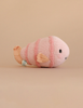 The Cuddle + Kind Baby Fish is a hand-knit pink and light peach plush with black stitched eyes and a small smile—an heirloom-quality collectible stuffed animal.