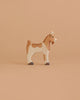 The Holztiger Goat is a small, handcrafted wooden toy with brown and white markings, a simple hand-painted design, and a friendly expression—just like classic HOLZTIGER figures made in Europe.