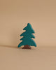 The Holztiger Handmade Wooden Animal Play Set features a simple wooden toy tree with green foliage and a brown trunk, crafted in a classic handmade style, standing upright against a neutral beige background.