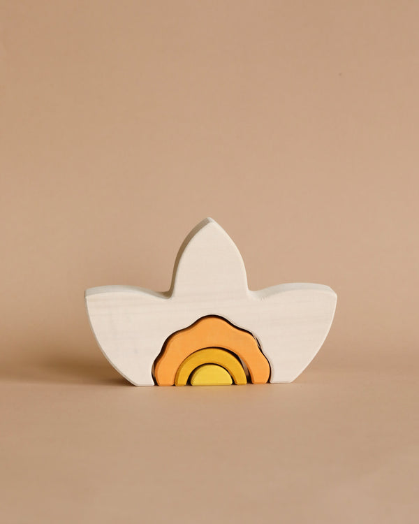 A Raduga Grez Arch Stacker - Narcissus Flower wooden toy shaped like a bird with a colorful design painted inside, featuring layers of orange and yellow, against a plain beige background.