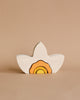 A Raduga Grez Arch Stacker - Narcissus Flower wooden toy shaped like a bird with a colorful design painted inside, featuring layers of orange and yellow, against a plain beige background.