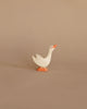 A simple handcrafted Ostheimer Goose - Head Up toy with a white body and orange beak and feet, standing against a plain beige background.